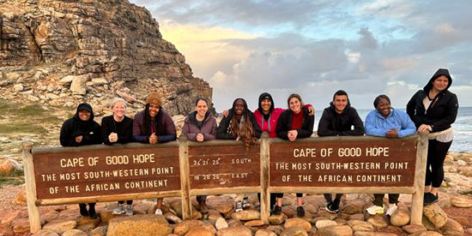 Crystal Sledge (far left), Toni Shoyinka (fifth from left), Allysia White (seventh from left) pose with their study abroad cohort at Cape of Good Hope in South Africa last summer (Photo courtesy of Toni Shoyinka)