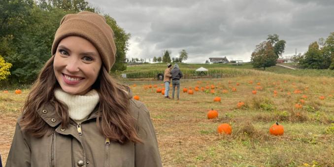 Emily Saxon standing in a pumpkin patch