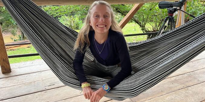 Erin Grohe lays in a hammock smiling 