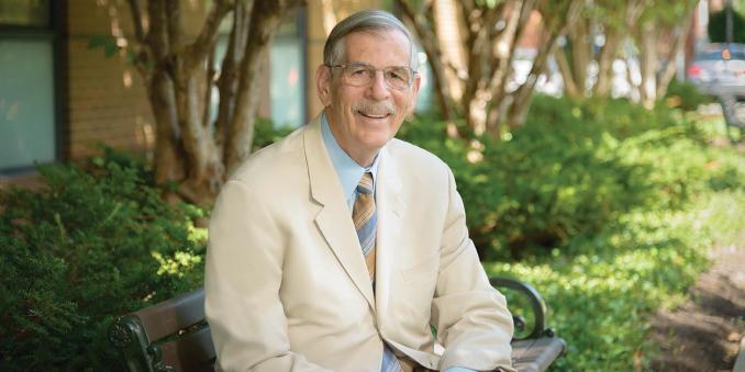 Terry Hokenstad sits on a bench outside the Mandel School