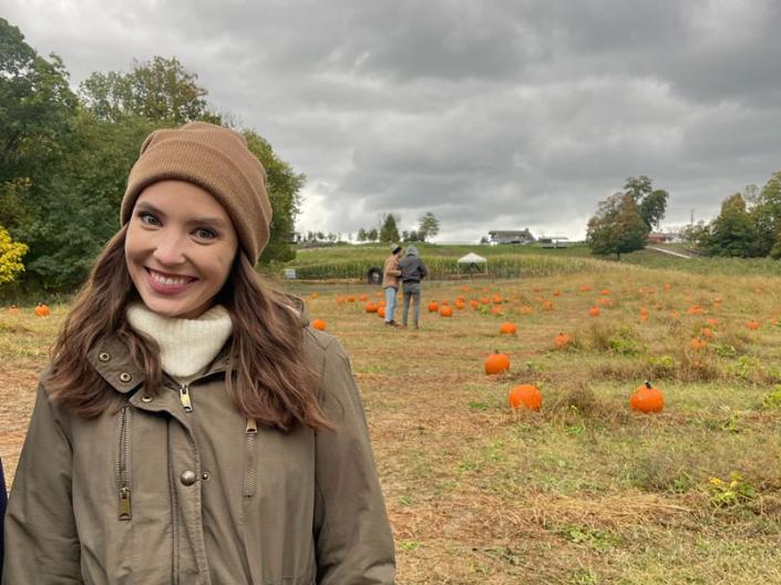 Emily Saxon standing in a pumpkin patch