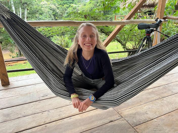 Erin Grohe lays in a hammock smiling 