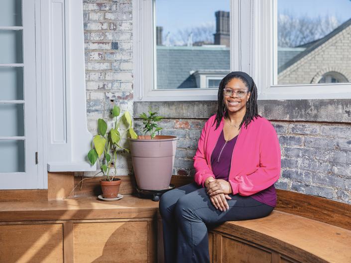 Lakecia Wild sits on a bench inside Magnolia Clubhouse