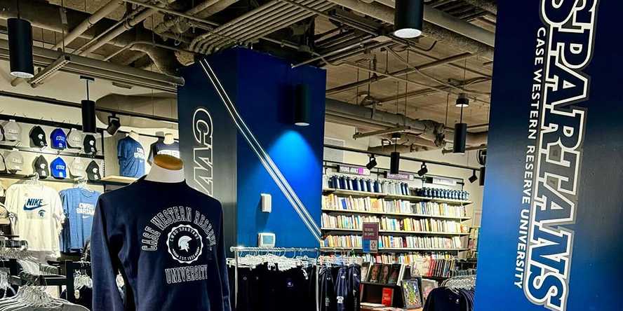 An inside view of Case Western Reserve University's bookstore with a mannequin, rows of merchandise and signage that reads Spartans.