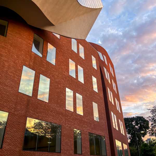 An upward angle of Weatherhead School of Management’s Peter B. Lewis building with a pink and blue sky in the background.