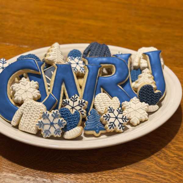 A plate of cookies, cut into CWRU letters and winter-themed shapes, like sweaters, mittens and snowflakes.