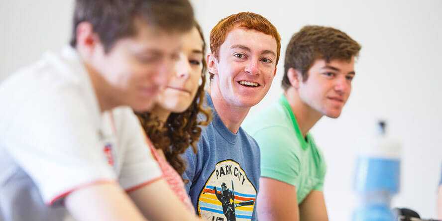 Photo of four Case Western Reserve University students sitting in a classroom