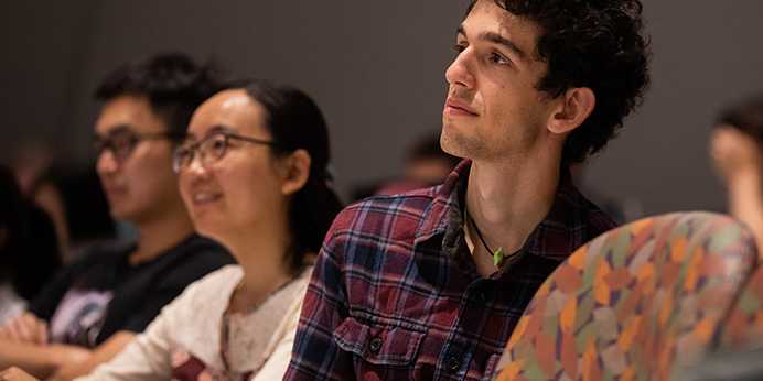 Photo of two Case Western Reserve University Weatherhead School of Management students listening to a lecture