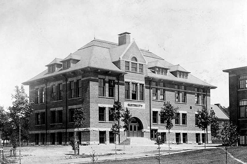 Black and white historical photo of a building on Case Western Reserve’s campus with a sign on it that says “Electricity”