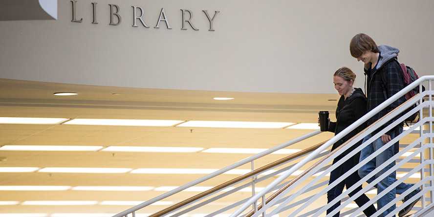 Photo of two Case Western Reserve University students walking down stairs of Kelvin Smith Library