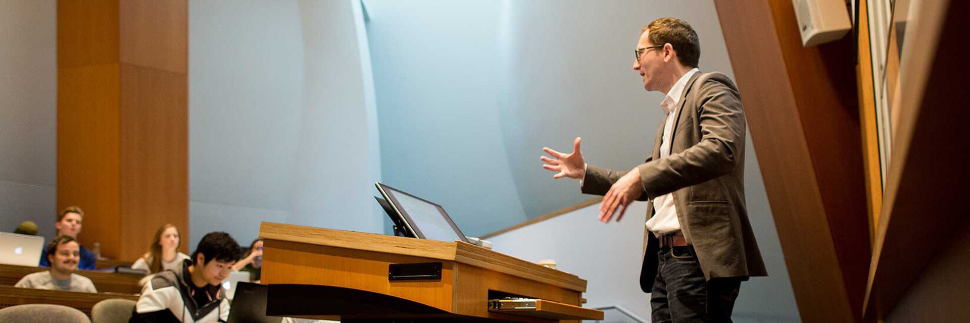 Photo of Case Western Reserve University Associate Professor Roman Sheremeta teaching a Weatherhead School of Management class