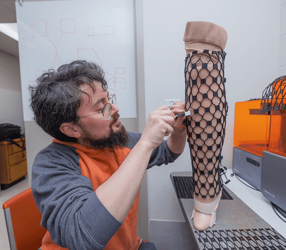 CWRU Engineering researchers working on on a prosthetic limb in a research lab.