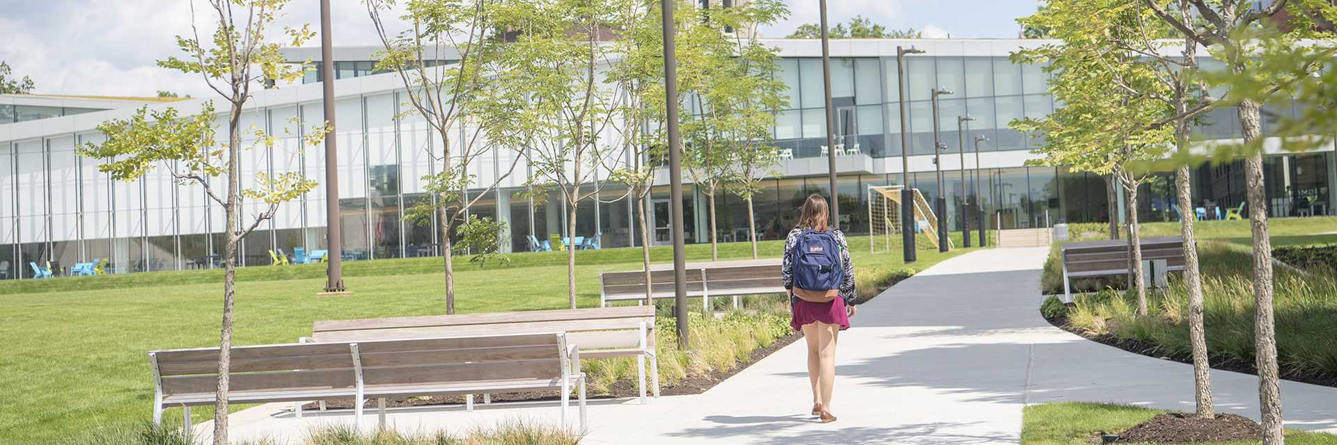 Photo of Case Western Reserve University’s Tinkham Veale University Center, with a student walking toward it