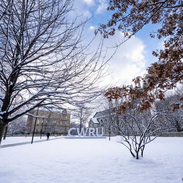 C-W-R-U letters sign covered in snow alongside the Binary Walkway.