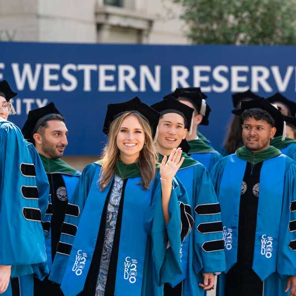 CWRU School of Medicine students walking through campus in their academic regalia