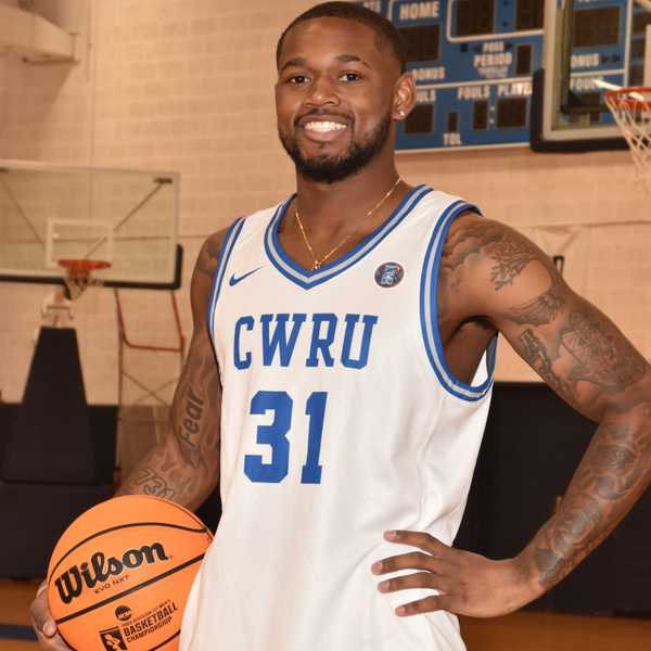 CWRU student Ethan Edwards poses with a basketball in Horsburgh Gymnasium.