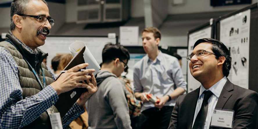 Photo of a Case Western Reserve University student talking with an employer at a campus event