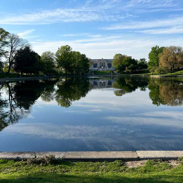The Cleveland Museum of Art in the background, with Wade Lagoon in the foreground and a reflection of the museum in its water.