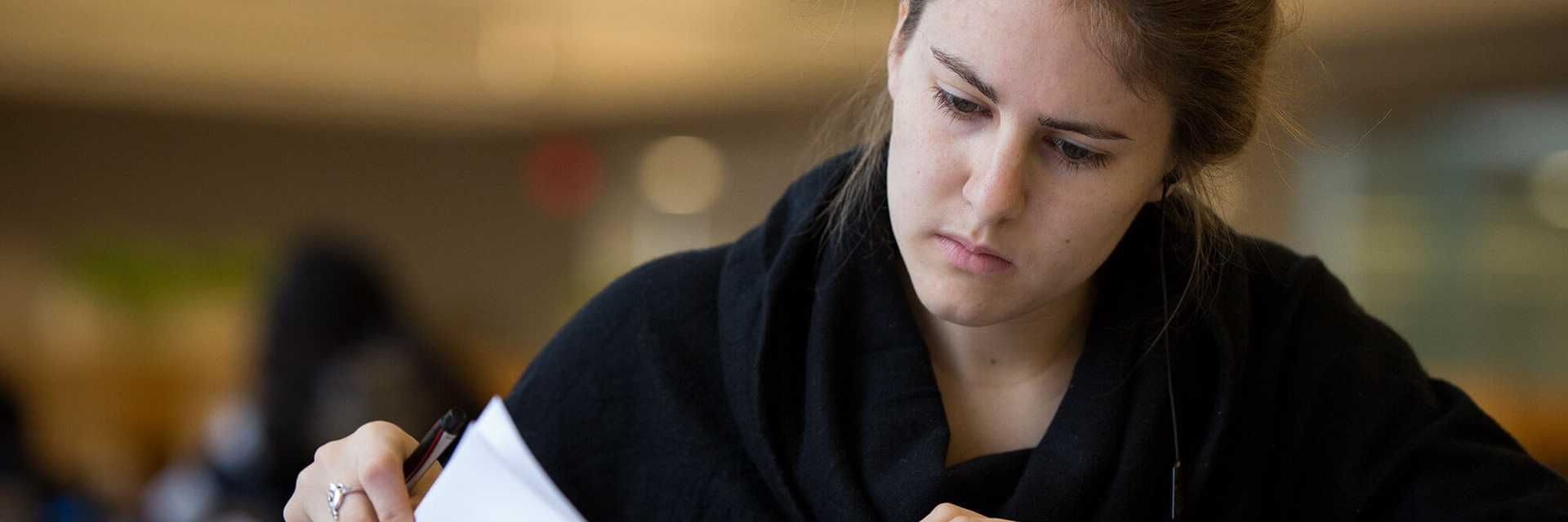 Close-up photo of a Case Western Reserve University student studying indoors