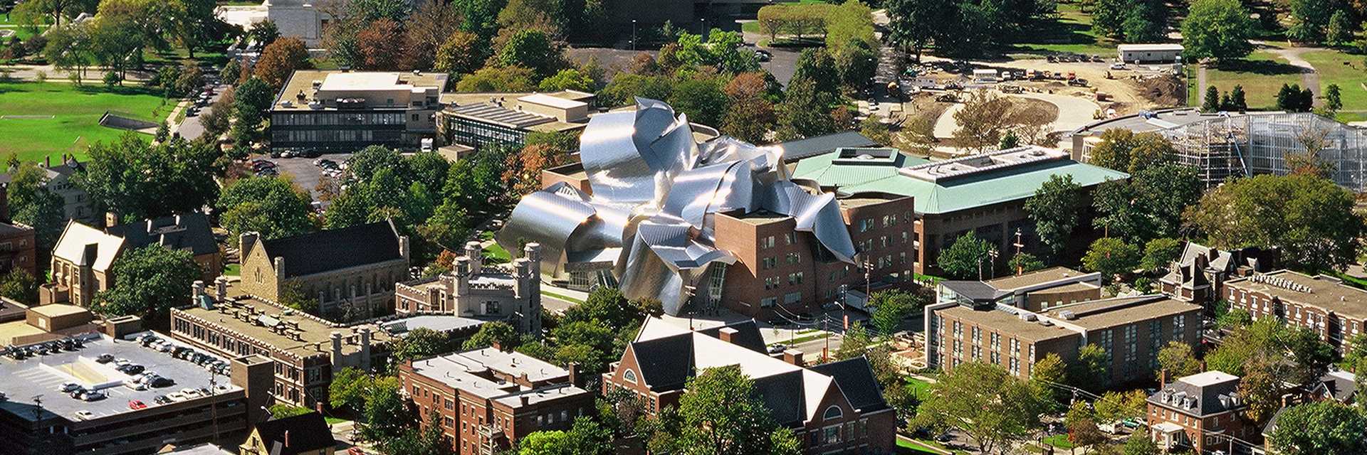 Photo of a Case Western Reserve University student walking across Mather Quad with prominent sun rays shining down