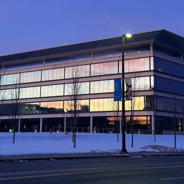 The sunset reflecting off the snowy Sheila and Eric Samson Pavilion building.