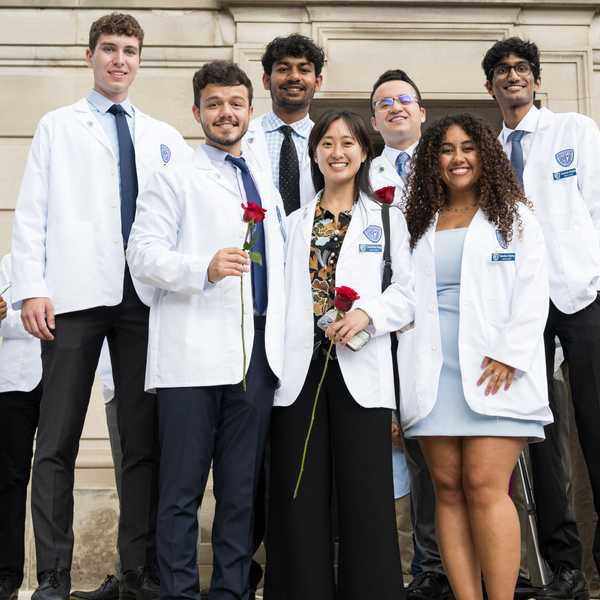 A group of seven incoming medical school students pose at the Case Western Reserve University white coat ceremony.