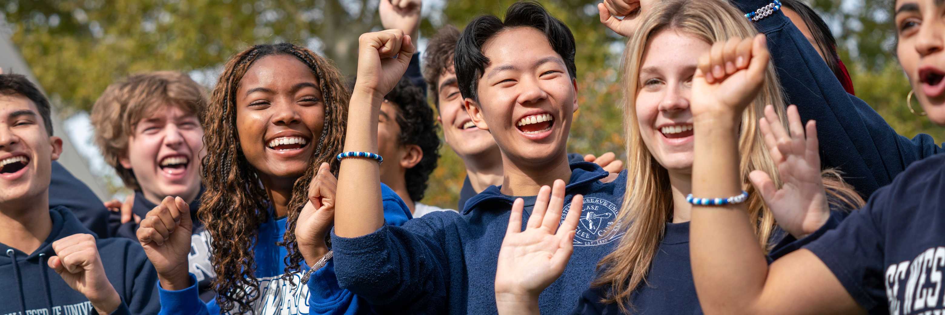Students cheer and wave at the Homecoming Spartan Tailgate