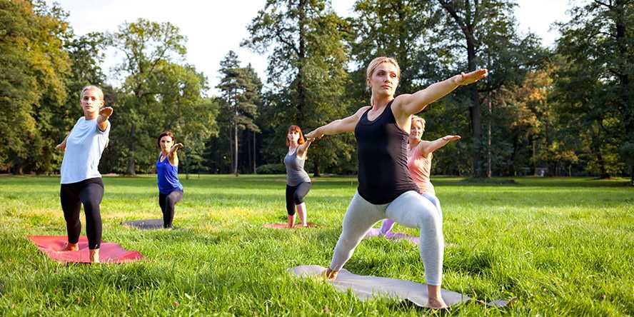 Photo of people doing yoga outdoors