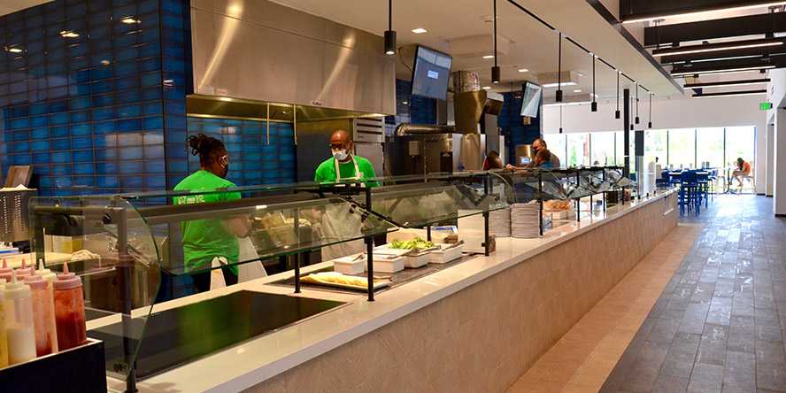 Photo of employees behind a foodservice counter in a Case Western Reserve University dining hall