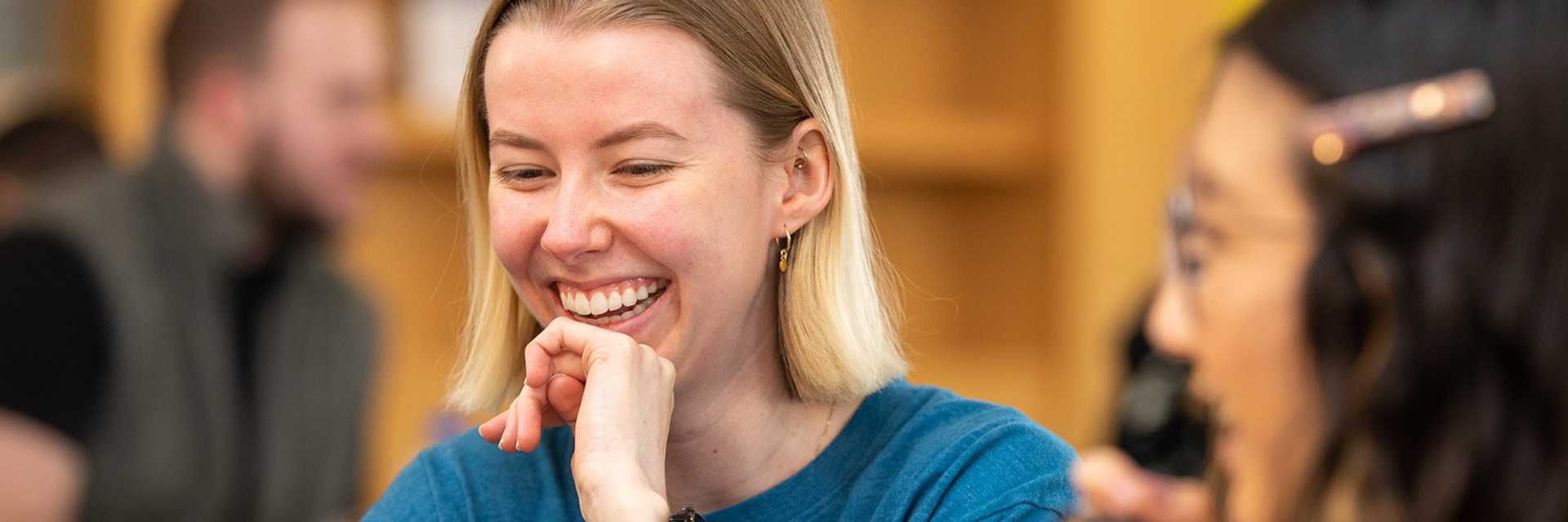 Close-up photo of a Case Western Reserve University student smiling in class