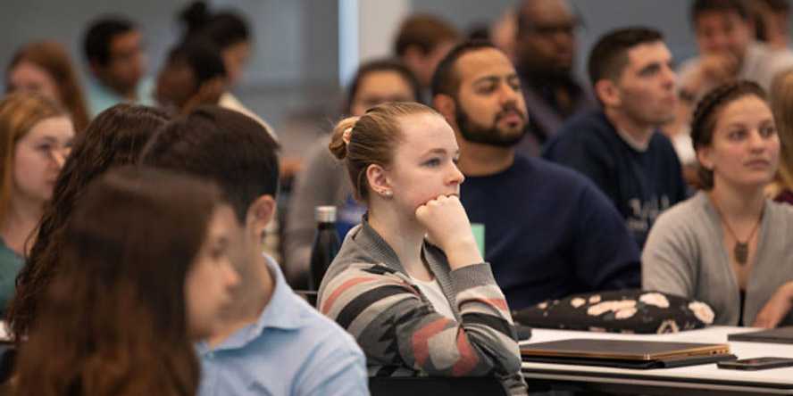 Photo of a full Case Western Reserve University classroom with students listening intently