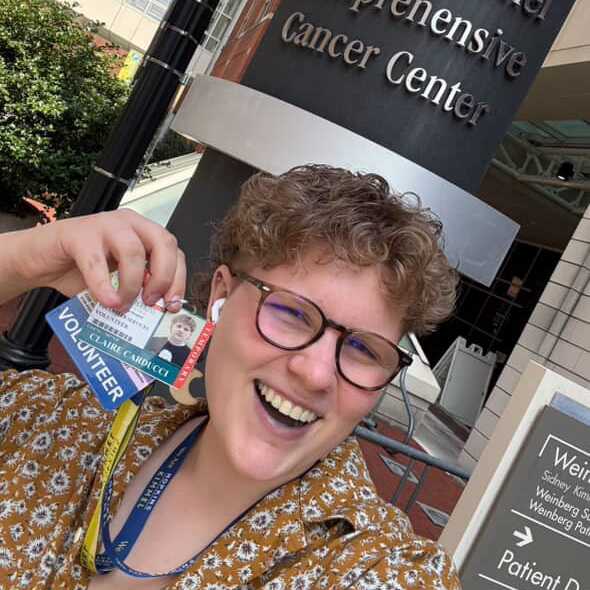 CWRU student Claire Carducci poses with her name tag at the Sidney Kimmel Comprehensive Cancer Center. 