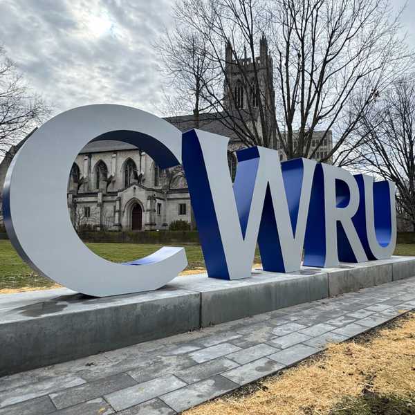 Large gray and blue letters near the university’s Binary Walkway that spell, “CWRU.”