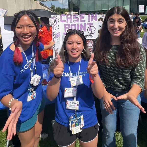 Three CWRU students at the Fall Student Activities Fair on Freiberger Field. 
