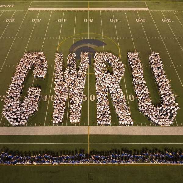 Over 1600 students gather on DiSanto Field in white and blue t-shirts to form the letters C-W-R-U.