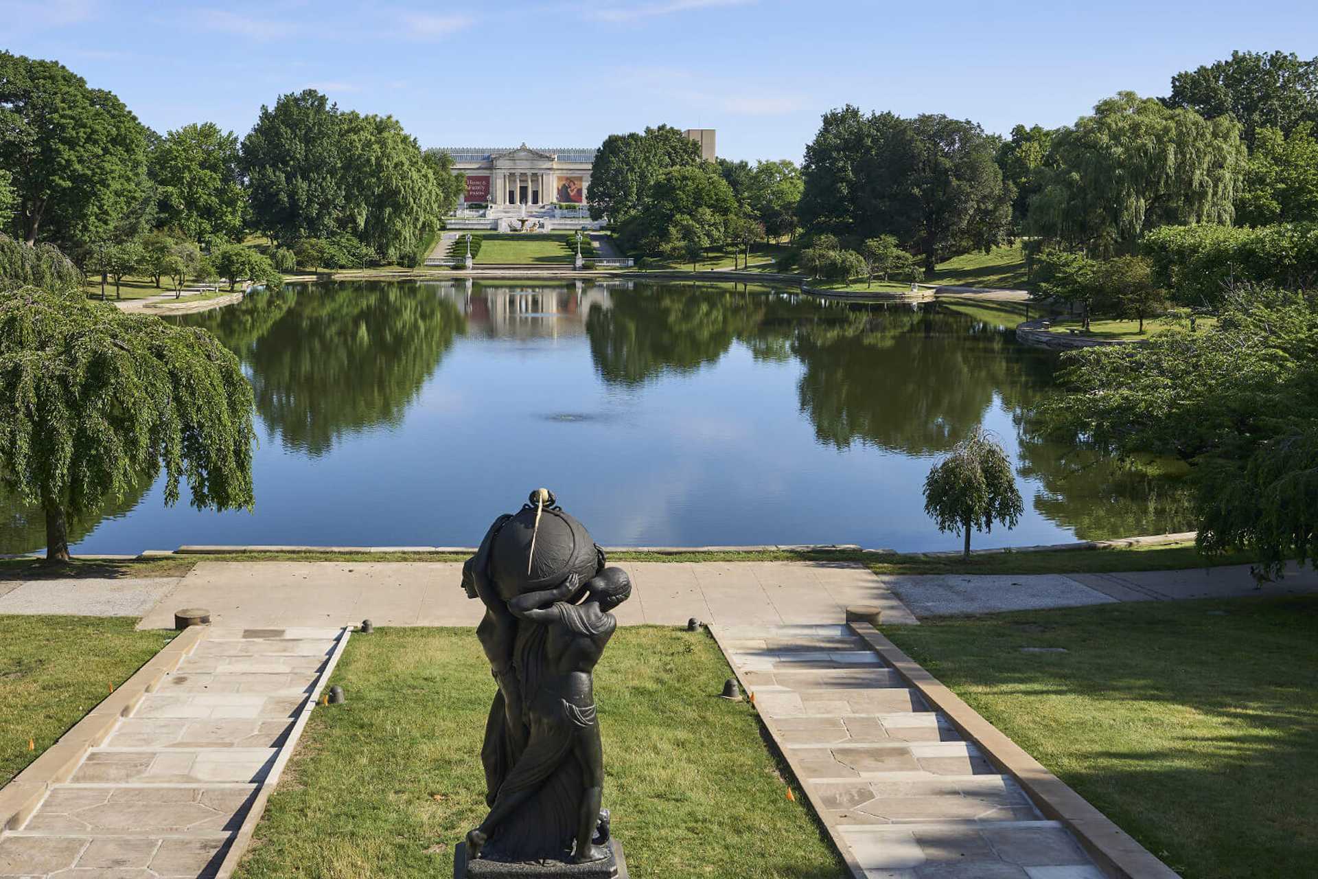 Photo of the Wade Lagoon near Cleveland Museum of Art with a statue in the foreground