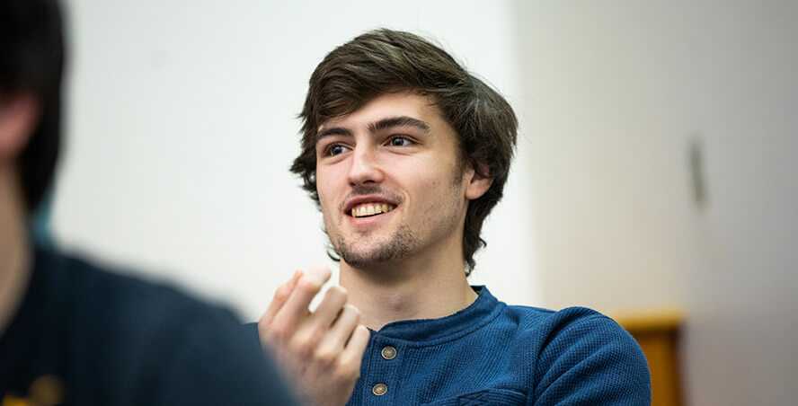 Photo of a Case Western Reserve University student in a classroom, smiling