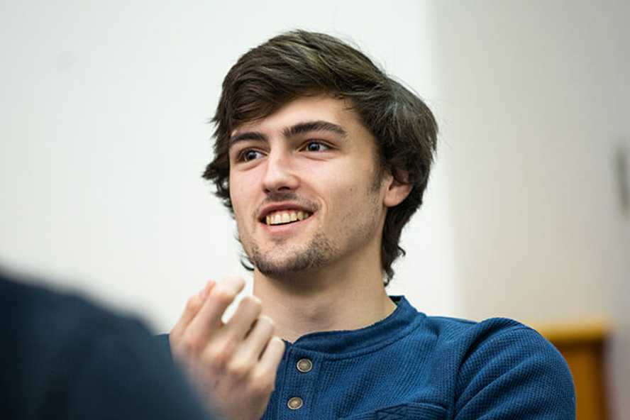 Photo of a Case Western Reserve University student in a classroom, smiling