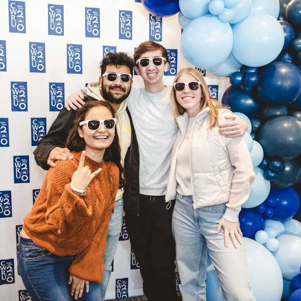 Four students posing in sunglasses at the CWRU bicentennial kickoff event.