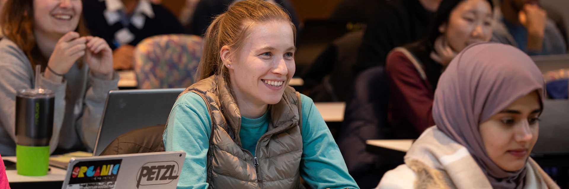 Photo of Case Western Reserve University students sitting in a classroom, smiling