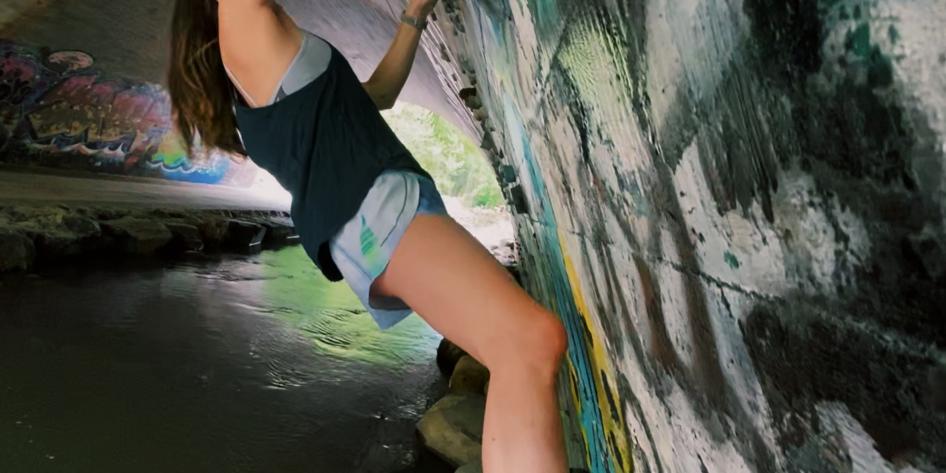 Person rock climbing in a tunnel