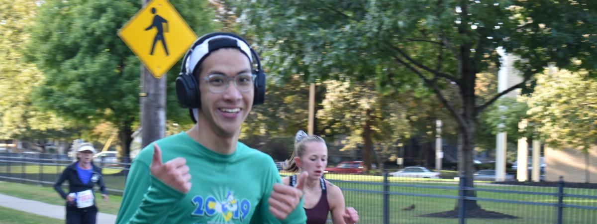 Man running with thumbs up