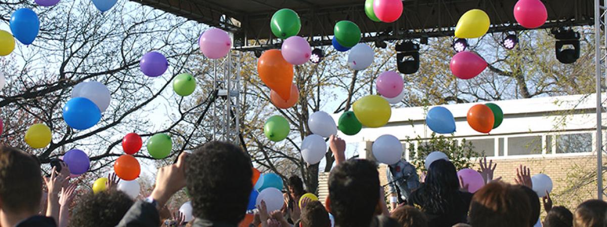 Students, balloons, and a stage during a lively event