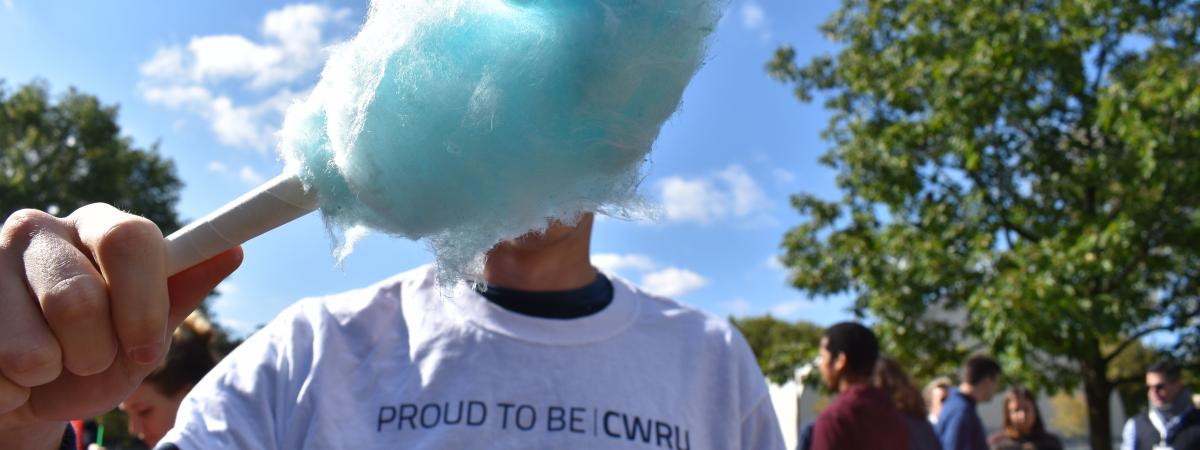 Person holding cotton candy in front of their face with a shirt that says proud to be CWRU