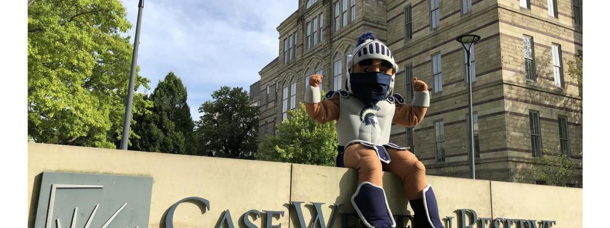 Spartie mascot sitting on the CWRU sign