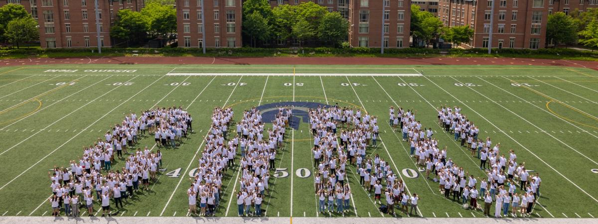 students standing in a football field spelling out CWRU