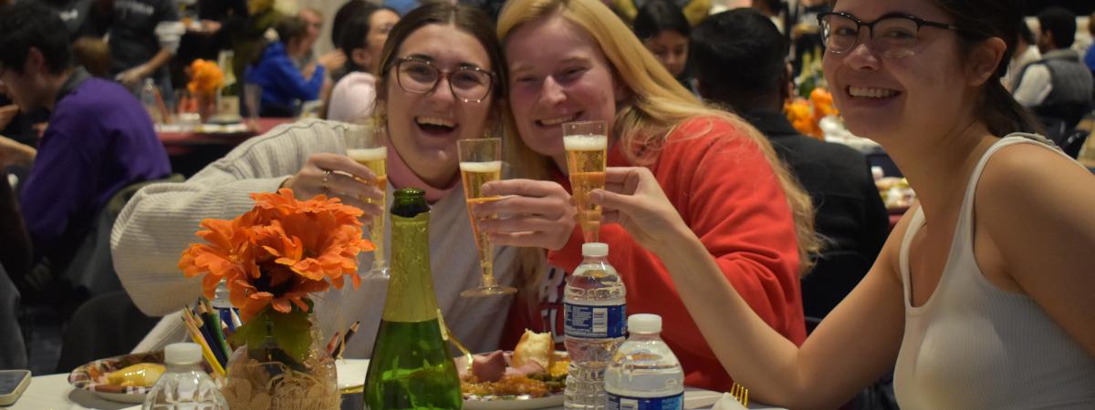 Students toasting during Thanksgiving meal