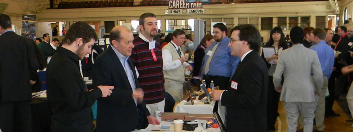 A group of employers and students at a Career Fair
