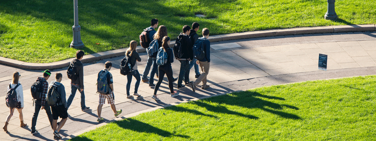 Aerial view of a group of students walking along a sidewalk on the campus of Case Western Reserve University