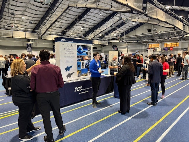 Career fair recruiter talking to students